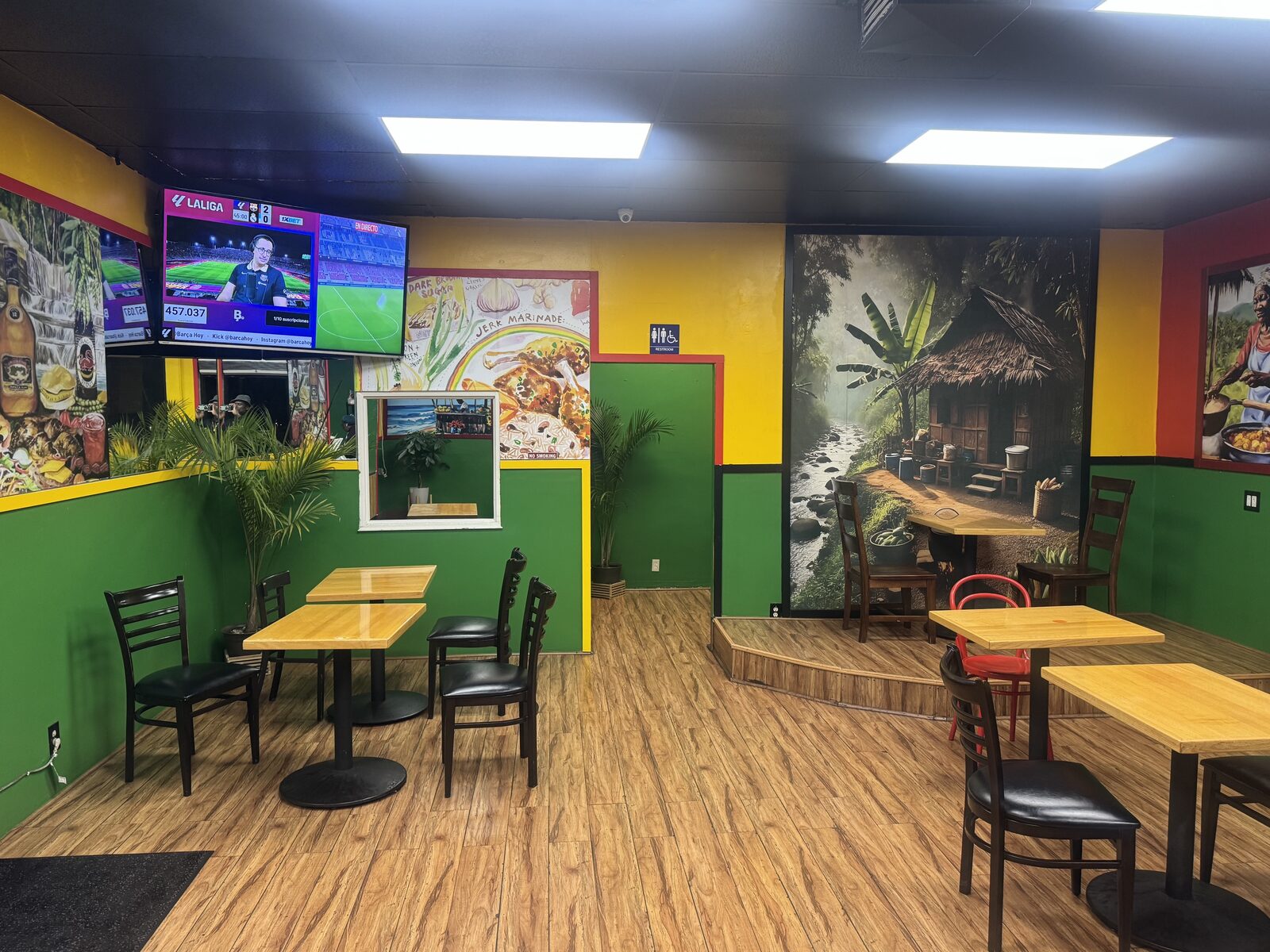 Inside Potwah Jamaican Cuisine — hand-painted Jamaican murals and dining room