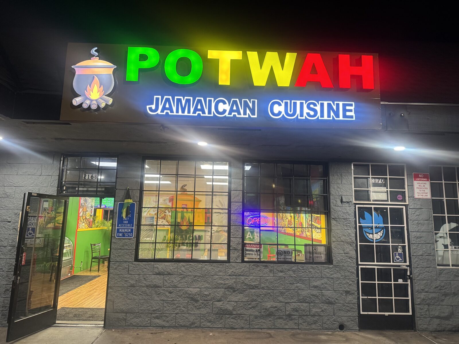 Potwah Jamaican Cuisine storefront on W Slauson Ave at night